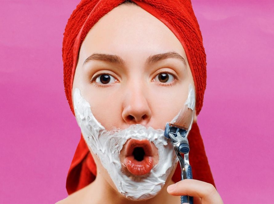 Women with cream on face about to shave her beard