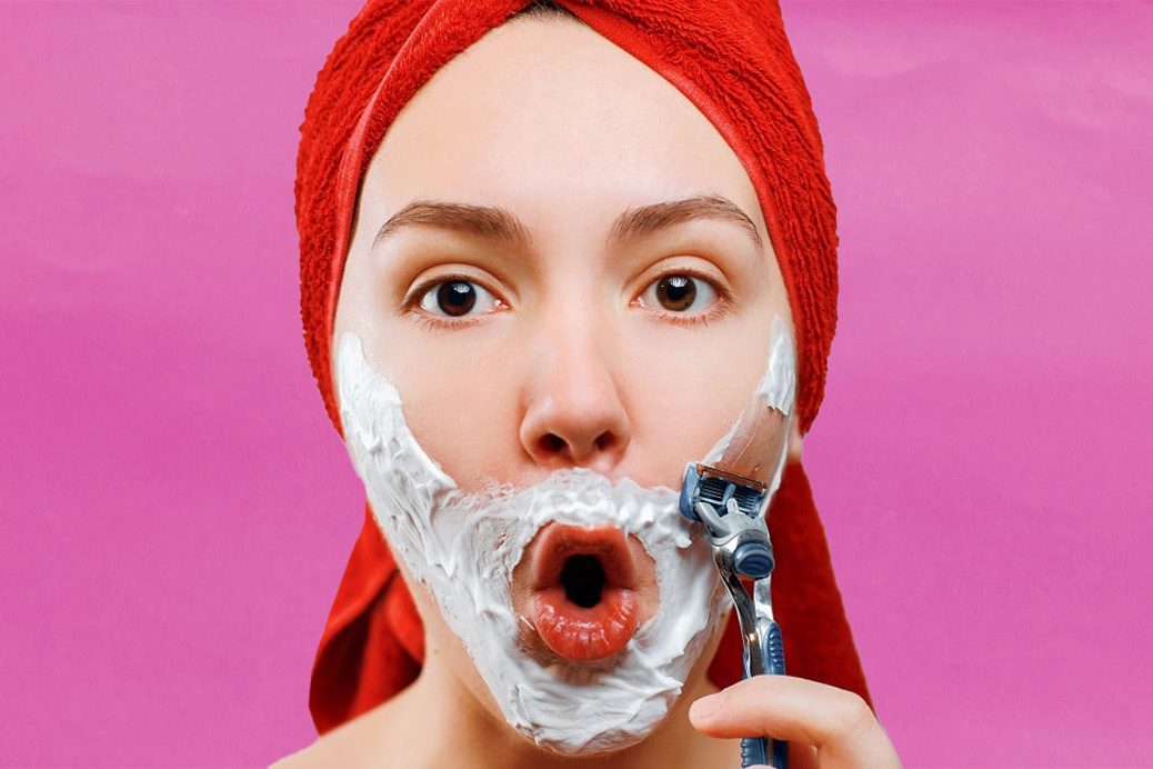 Women with cream on face about to shave her beard