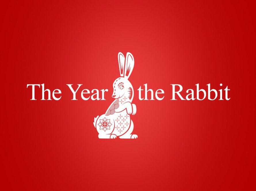 Words 'The Year of the Rabbit' on a red background with a illustration of a rabbit in the centre