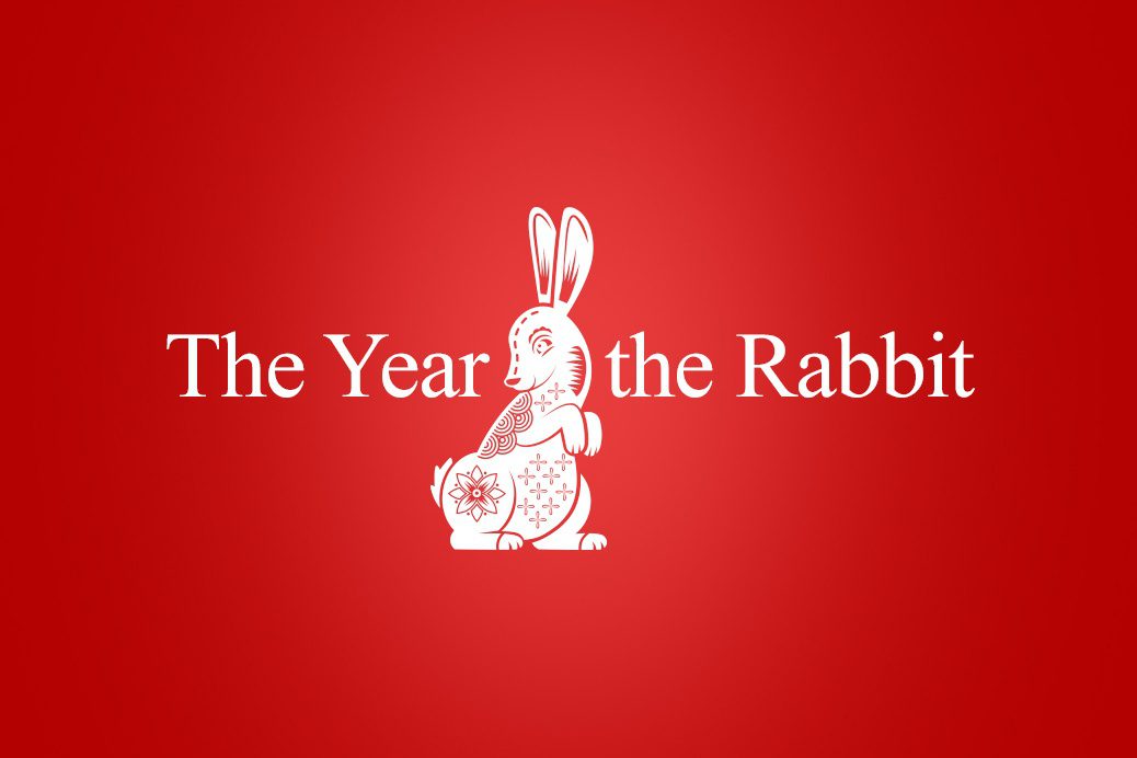 Words 'The Year of the Rabbit' on a red background with a illustration of a rabbit in the centre