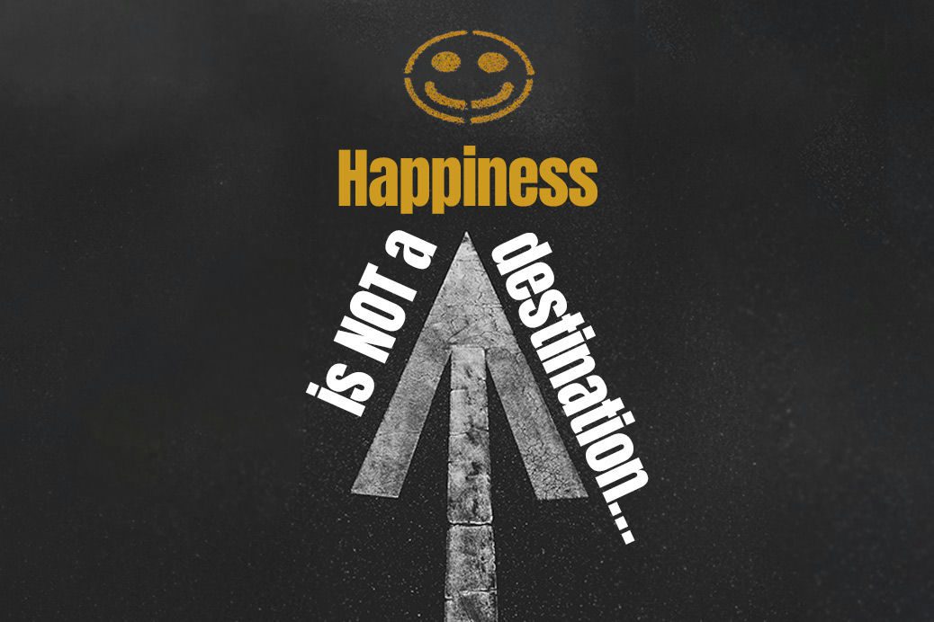 Words 'Happiness is not a destination' written on a road in paint